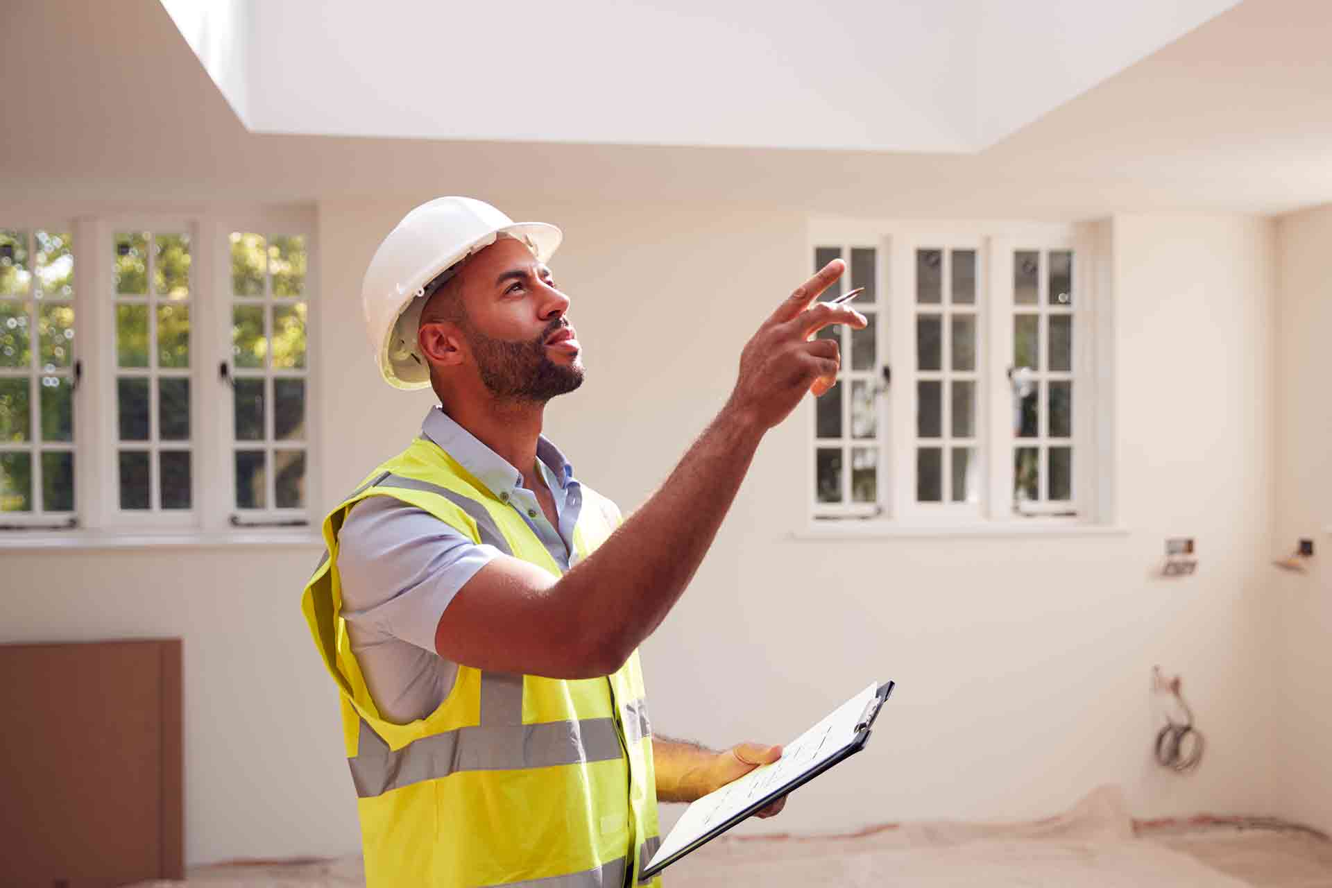 Third Party Wall Surveyors Northampton reviewing plans between two parties during a dispute